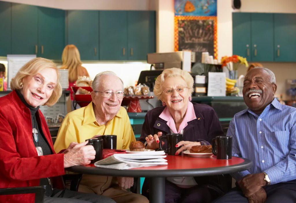 A group of people sitting at a table with drinks.