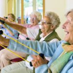 A group of older people holding onto some ropes