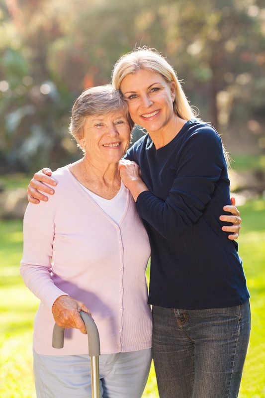 A woman and an older lady posing for the camera.