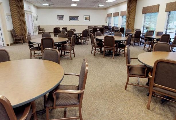 A large room with many tables and chairs.