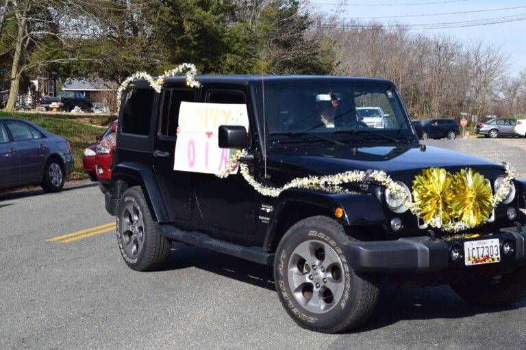 A black jeep with flowers on the side of it.