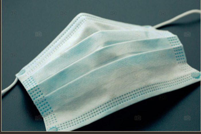 A close up of a surgical mask on a table