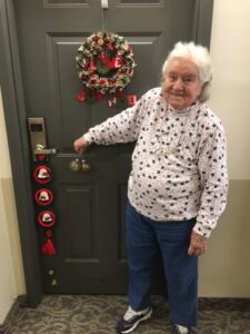 A woman standing in front of a door.