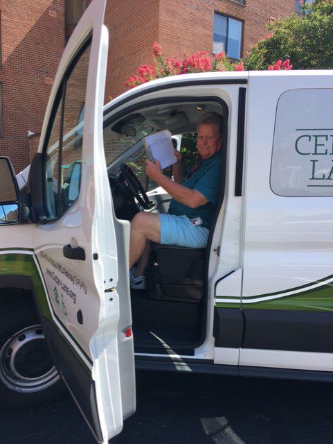 A man sitting in the drivers seat of a van.