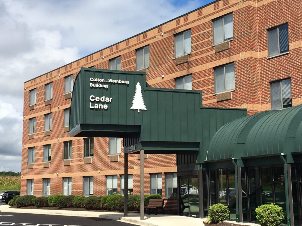 A hotel with a sign that says cedar lane.