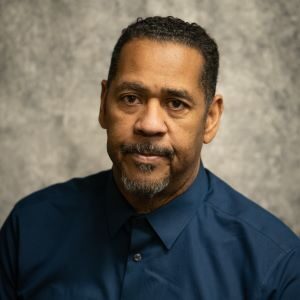 A man in a blue shirt and black tie